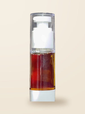 The travel mini of Thee Growth Serum, a small clear pump bottle of amber oil